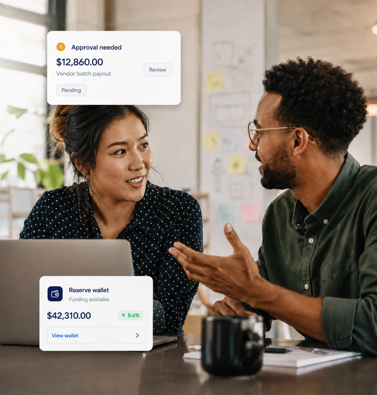 Two colleagues reviewing a pending payout approval together